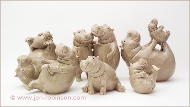 ceramic hippo playing with their babies sculptures