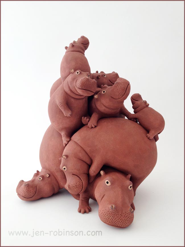 stoneware sculpture of a pile of 9 hippos