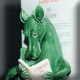 Ceramic bookend of a dragon reading a fairy stories book