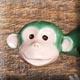 green hanging monkey sculpture