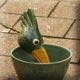 green feeding bird sculpture