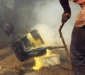 the molten bronze is poured into the moulds